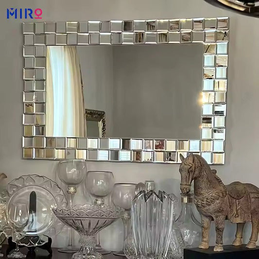 Elegant rectangular wall mirror with a mosaic-style mirrored tile frame displayed above a console table- Fabels